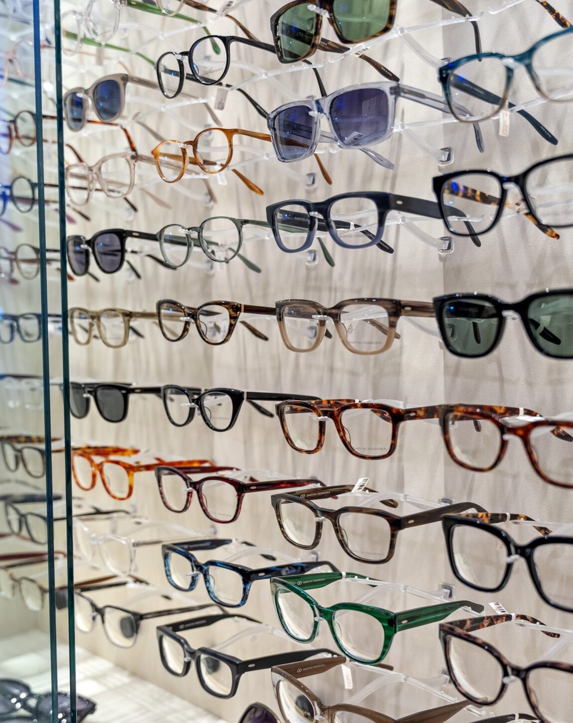A wall of designer frames inside MacPherson Opticians.
